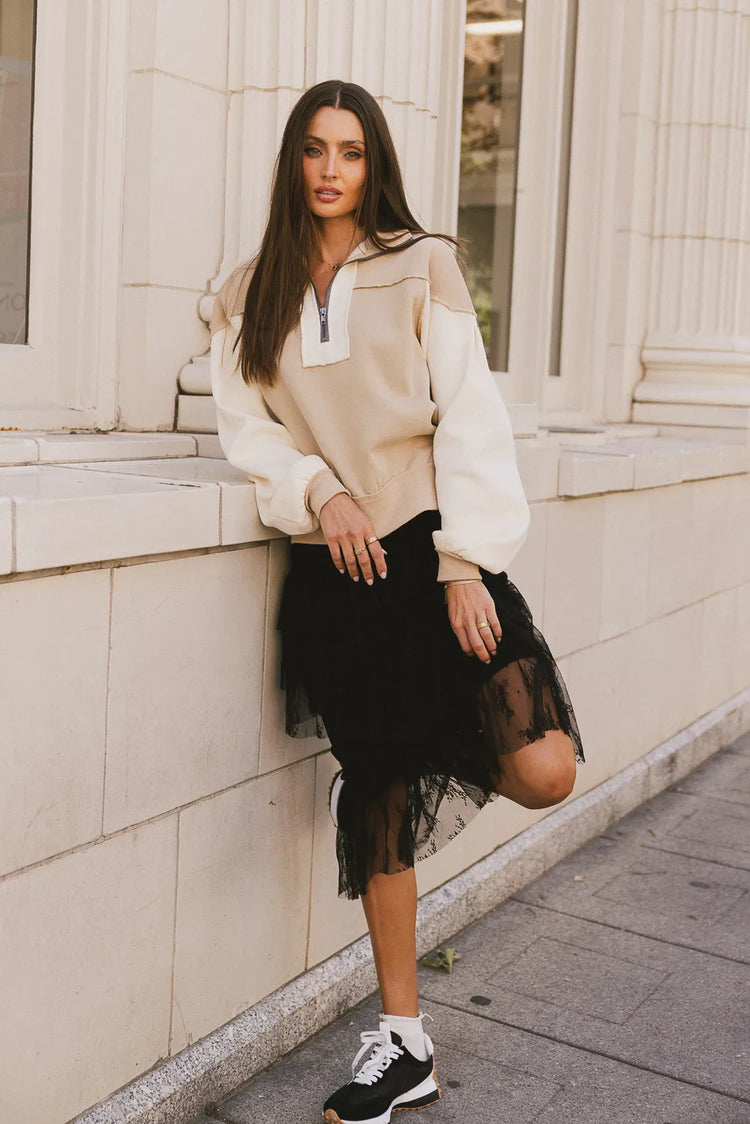 Long sleeves sweater in tan paired with a black lace skirt 