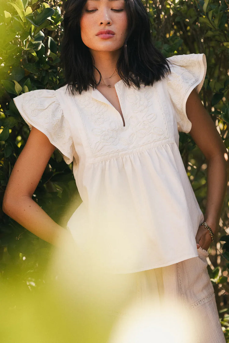 round deep v neck on cream blouse