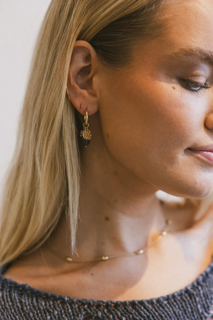 Gold earrings with purple pendants 