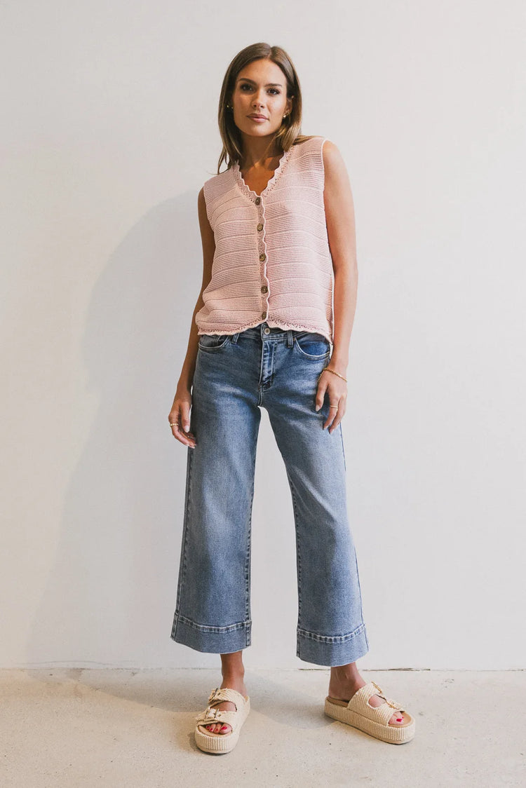 Vest in pink paired with a denim in light wash 