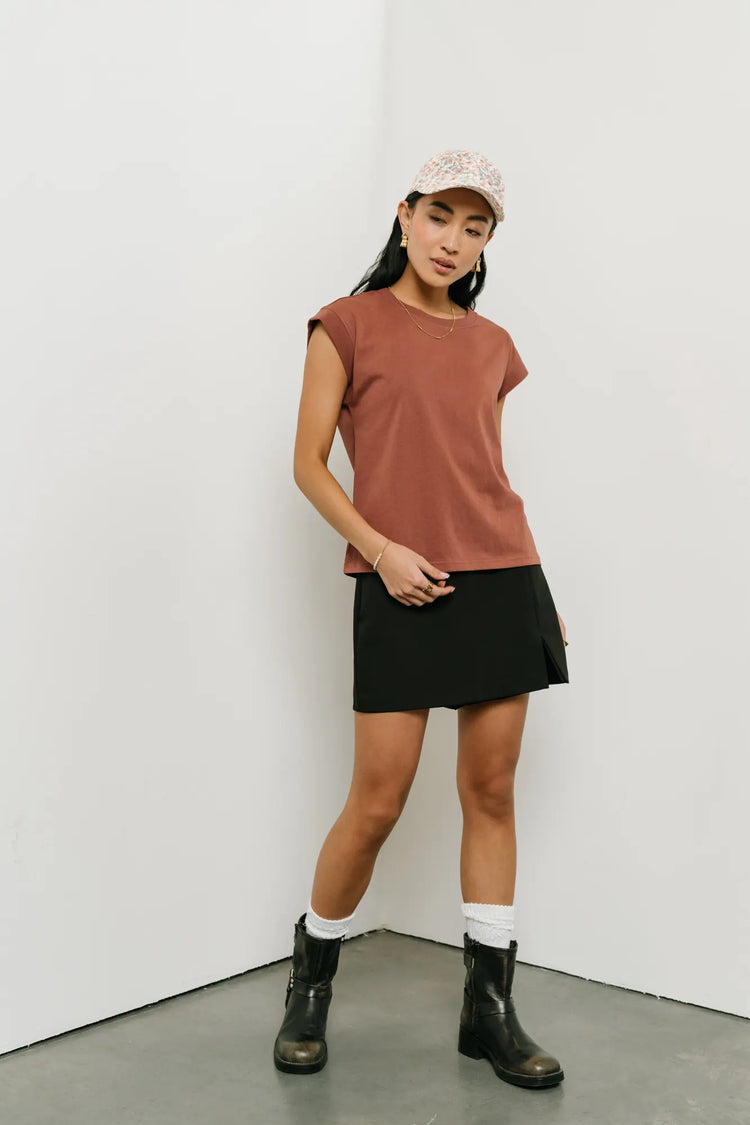 Basic top in brick paired with a mini black skirt 