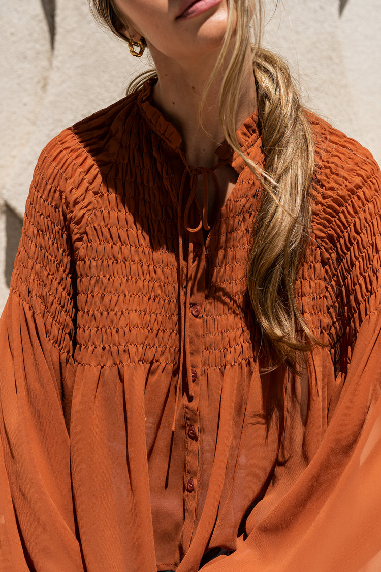 rust blouse with tie front closure