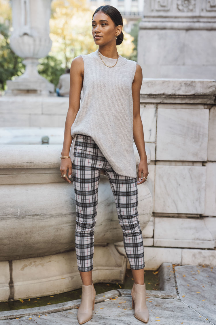 Model wears the Mikel Plaid Pants with a cream sweater top and taupe booties. Pants are cropped and skinny fit.