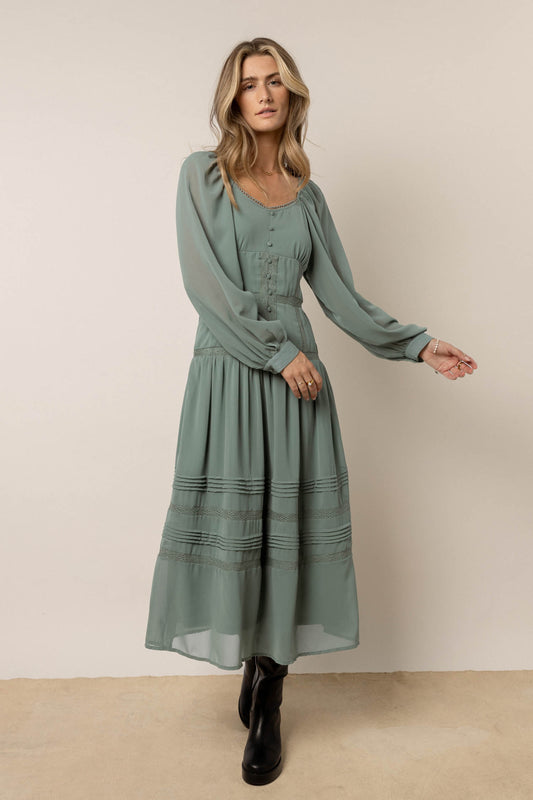 model wearing sage dress with buttons