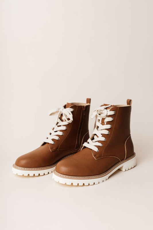 The Aurora Combat Boots in Brown have white laces and a faux leather upper with a white sole.