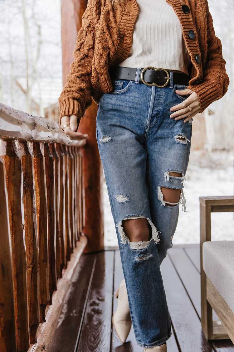 woman in straight leg high rise distressed denim jeans