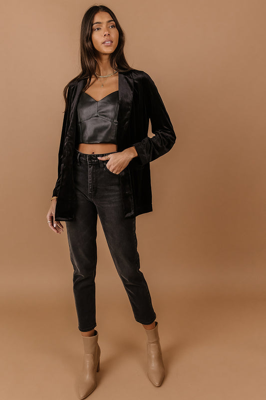 Model wears the Vero Moda Audrey Velvet Blazer with a black tank top, charcoal wash denim, and nude pointed toe heeled boots.