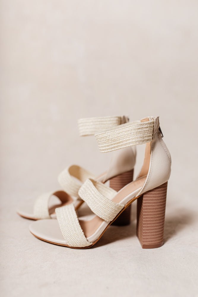 The Preslyn Heels have two textile straps across the foot, one textile ankle strap, tall block heel, and zipper on the heel.