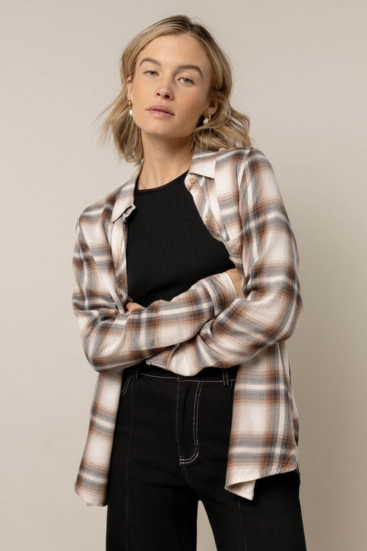 model wearing plaid button down paired with black pants 