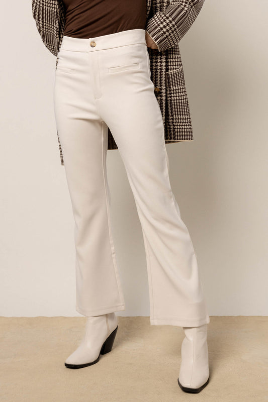 model wearing cream trousers paired with cream boots 