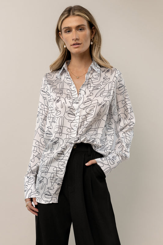 white button down blouse with abstract detail