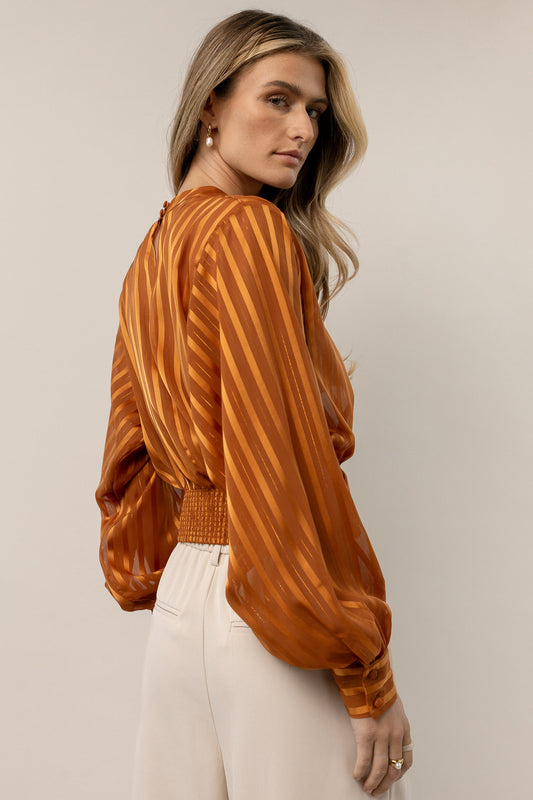 orange striped blouse with long sleeves