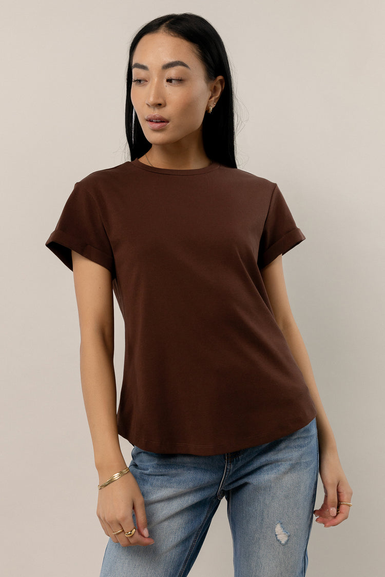 model wearing brown short sleeve tee with rolled sleeves