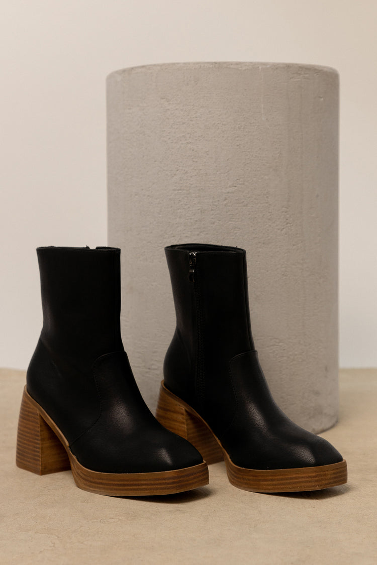 black boots with brown wood detail