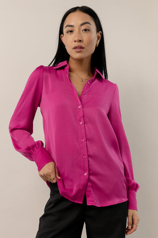 model is wearing magenta button up top with black pants