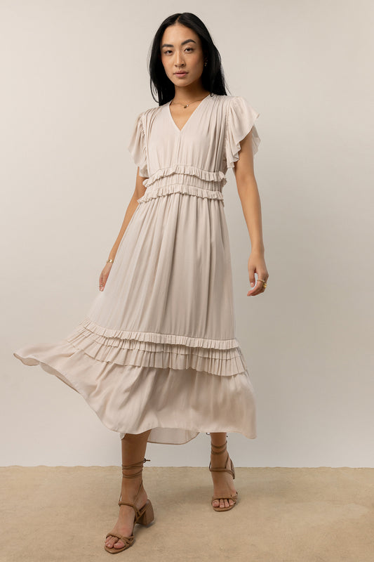 model wearing ivory short sleeve midi dress with ruffle detail