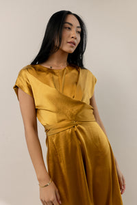 model wearing mustard short sleeve midi dress with front crisscross detail