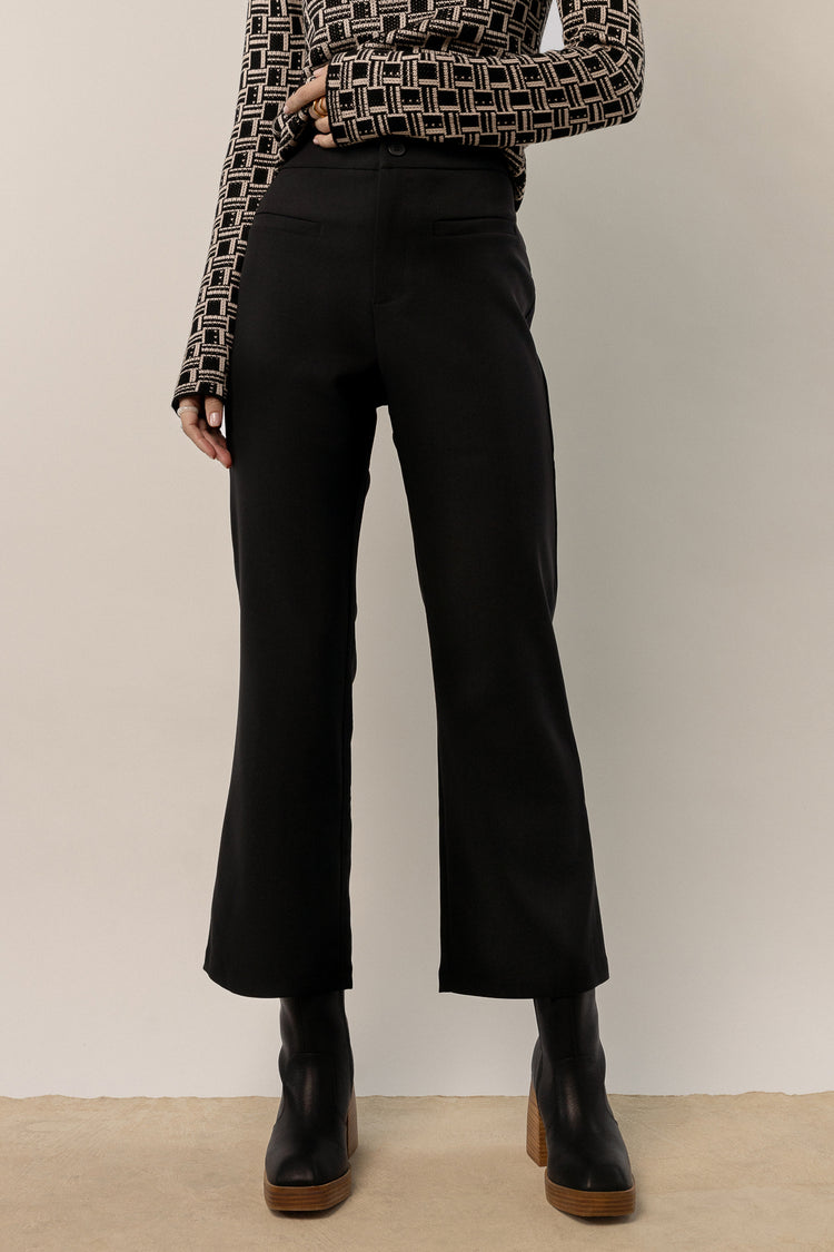 model wearing black wide leg trousers