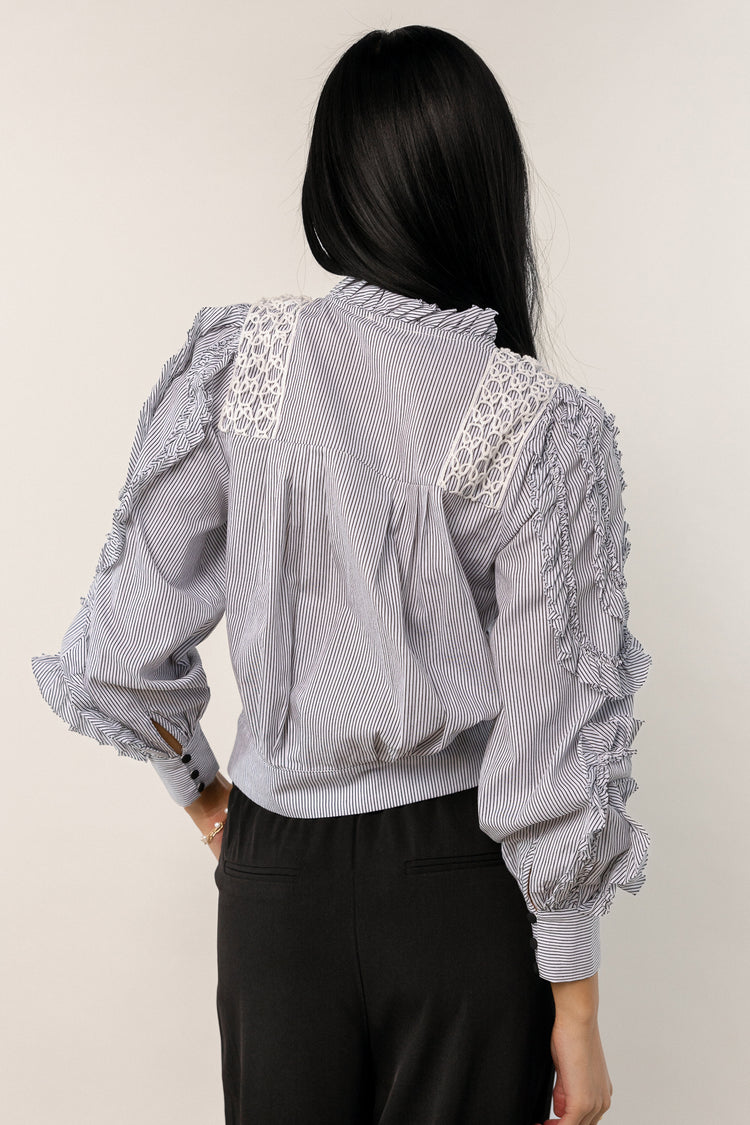 black blouse with ruffle detail