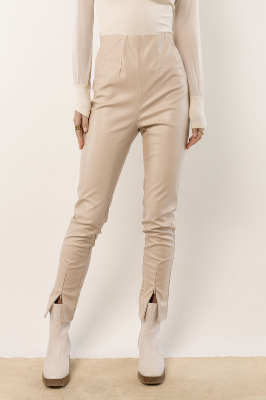 model wearing oatmeal leather pants with ankle zipper 