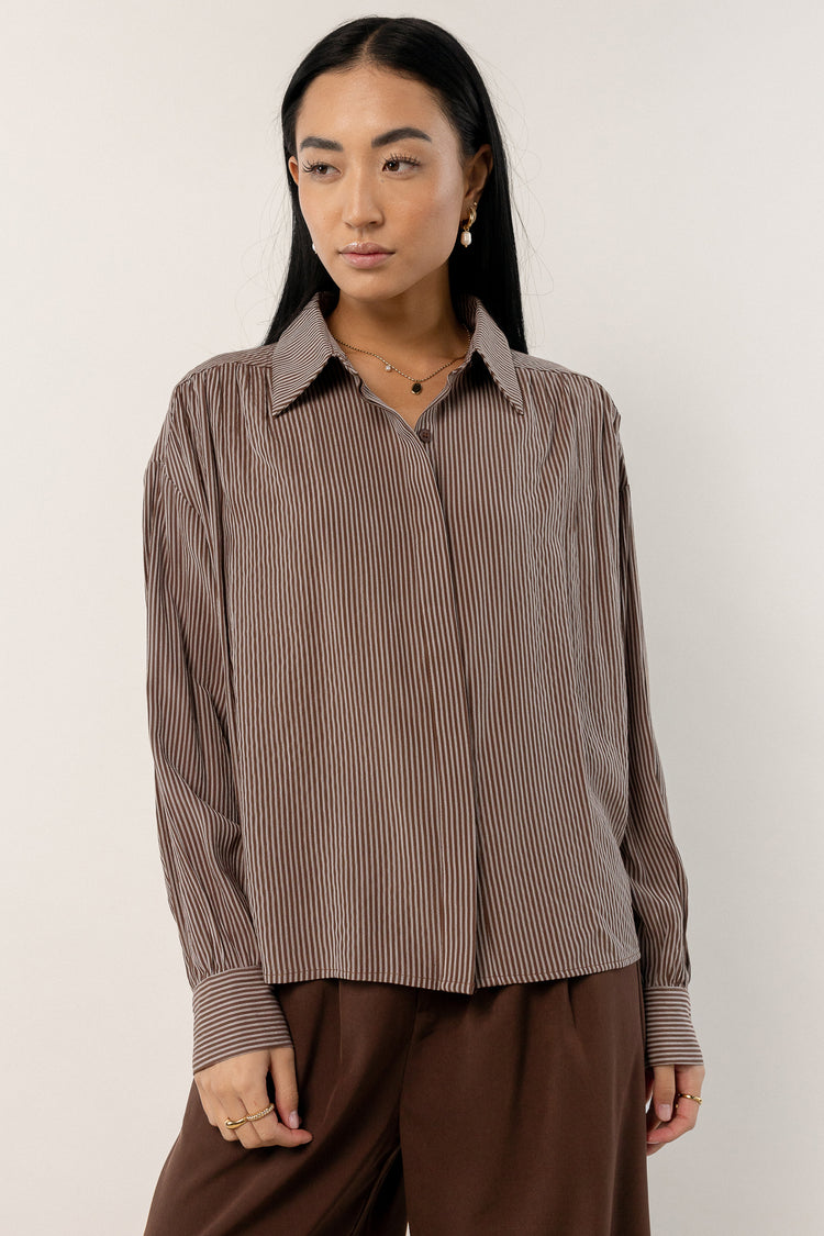 brown button up top with striped detailing