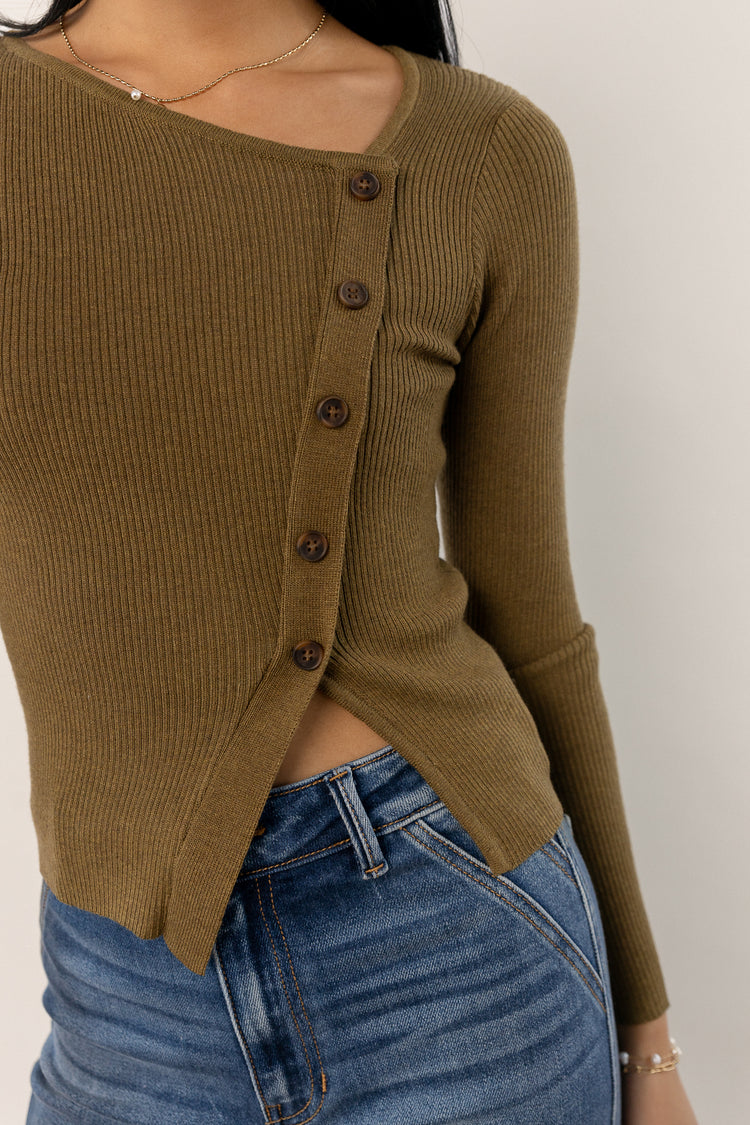 model wearing olive long sleeve ribbed shirt with button detail