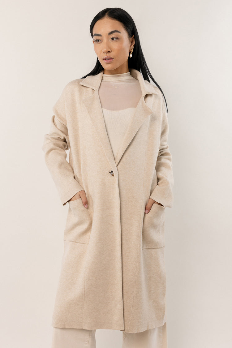 model wearing ivory oversized trench coat