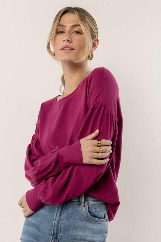 model is wearing puff sleeve top with denim