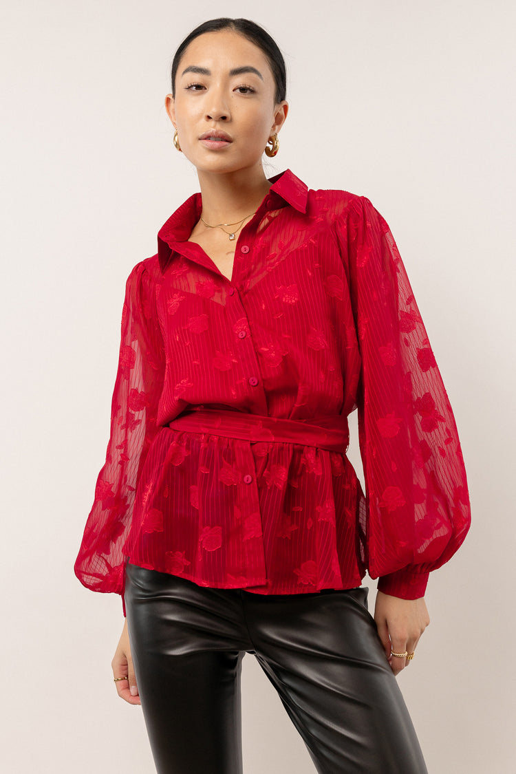 red peplum blouse with sheer sleeves