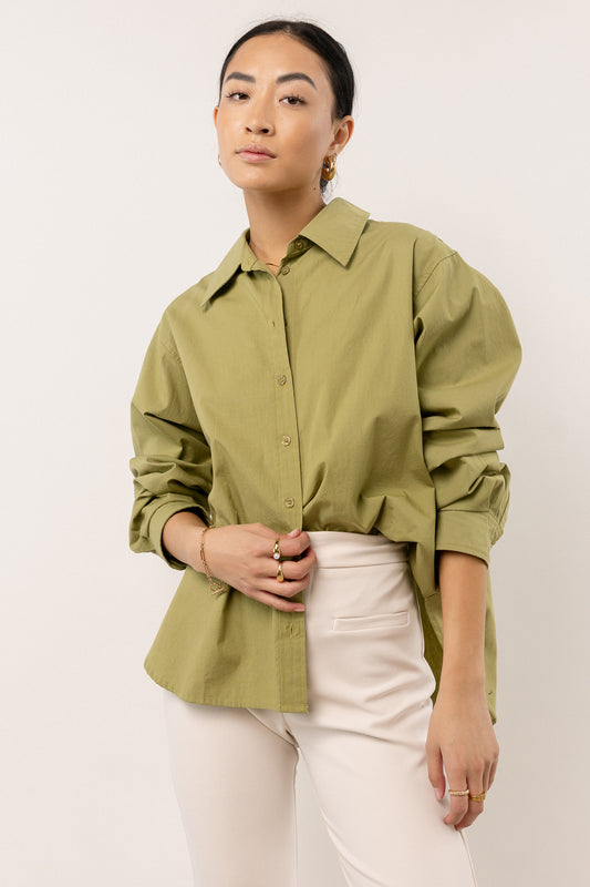 model wearing long sleeve green button down