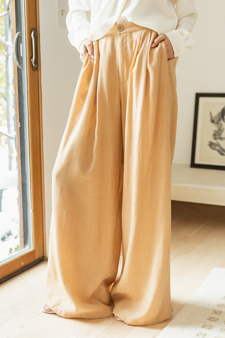 peach long trousers with cream dressy top 