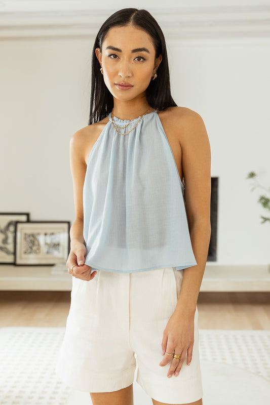 sleeveless baby blue top with white shorts