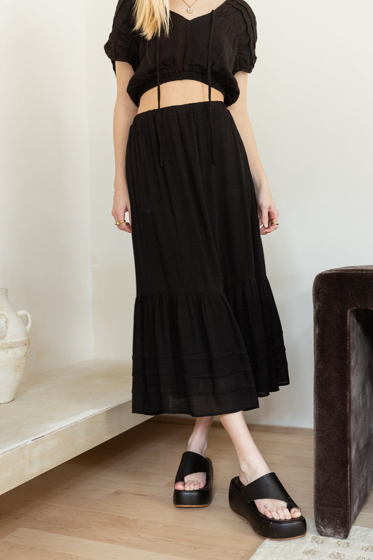Tiered midi skirt paired with a black top 