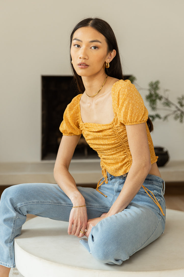 square neck crop top and light wash jeans