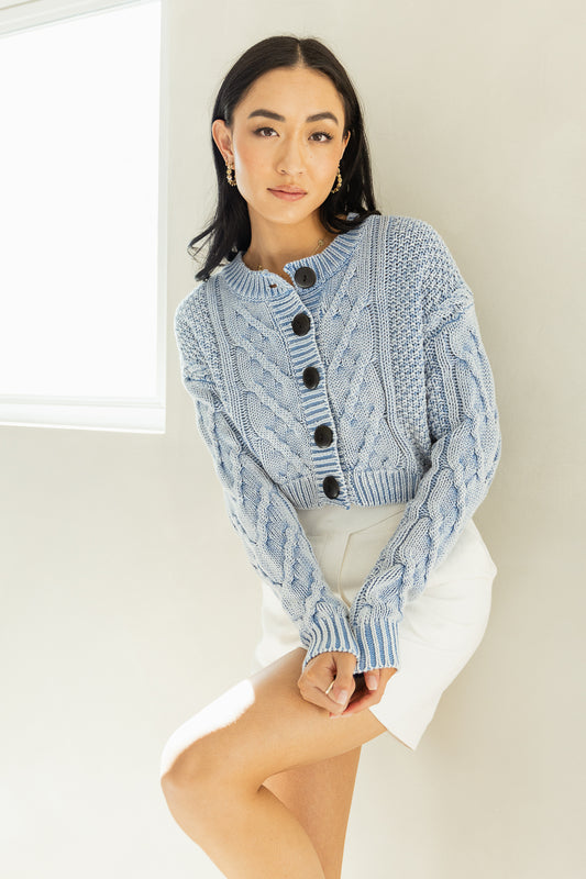 blue cable knit cardigan with button front closure