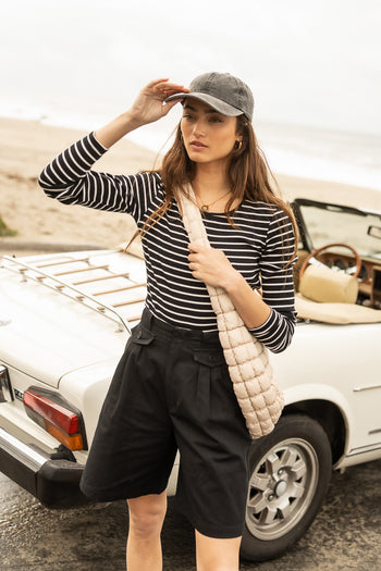 Bermuda short paired with a striped long sleeve top 