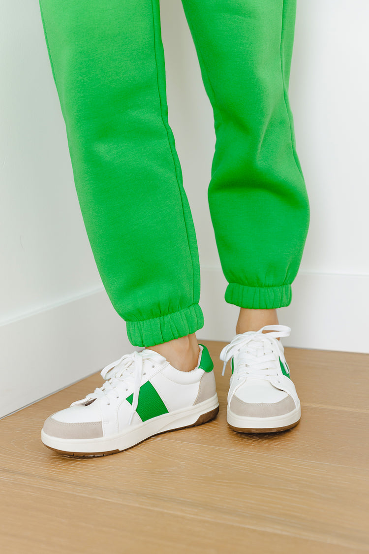 green sweater pants and green and white sneakers