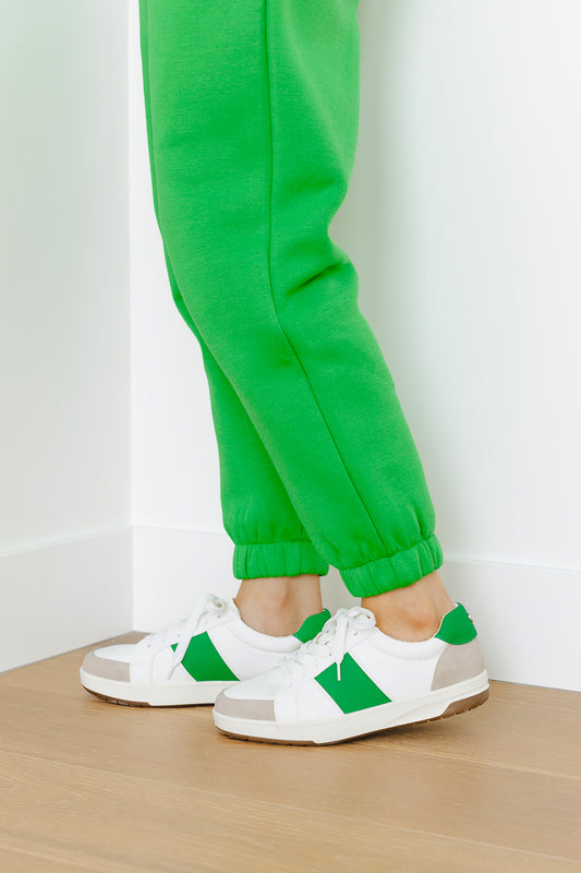 side view of womens sneakers with green sweatpants