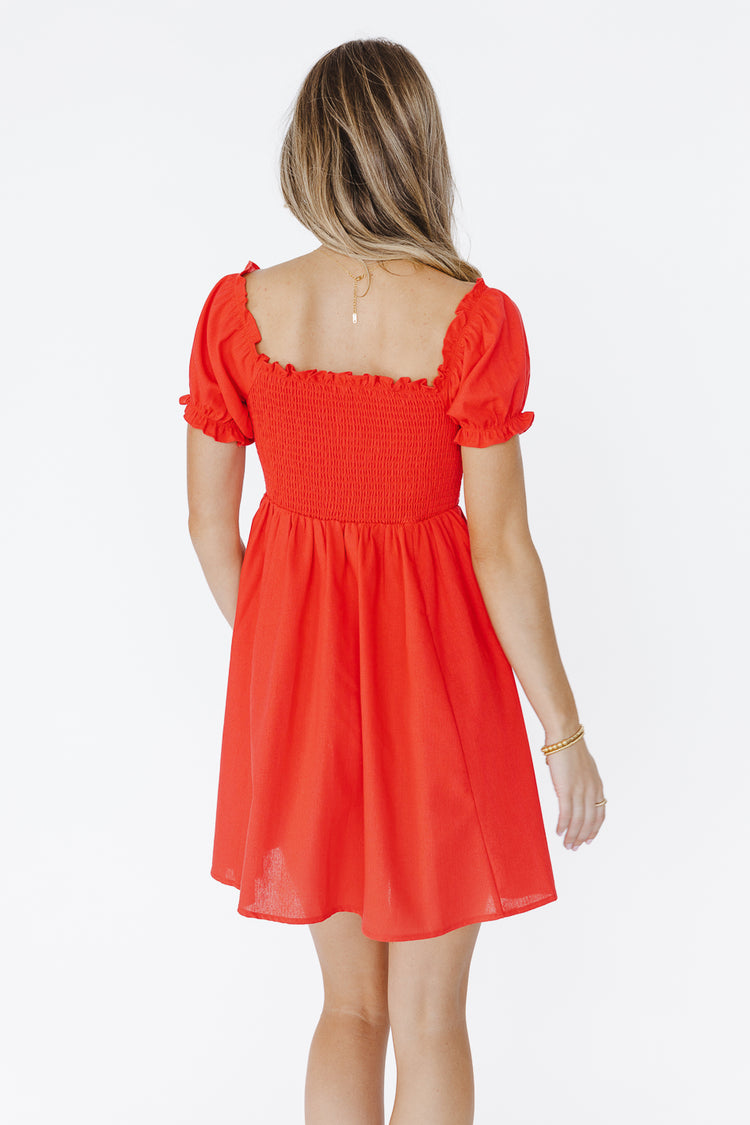 backside of red mini dress with smocked top 