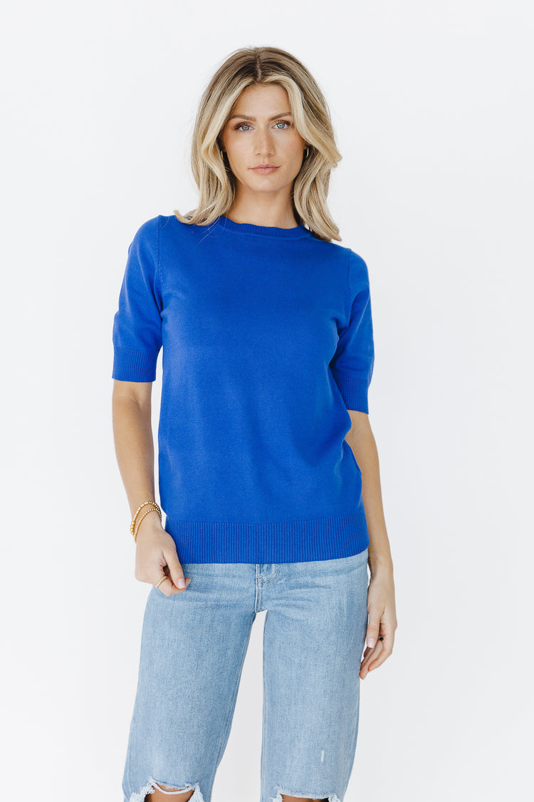 short sleeve blue sweater paired light wash jeans