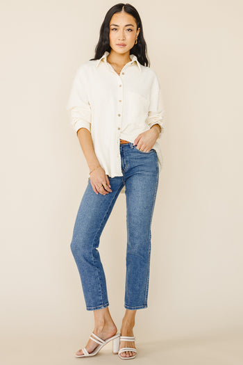 Straight legs in medium wash paired with a white button up