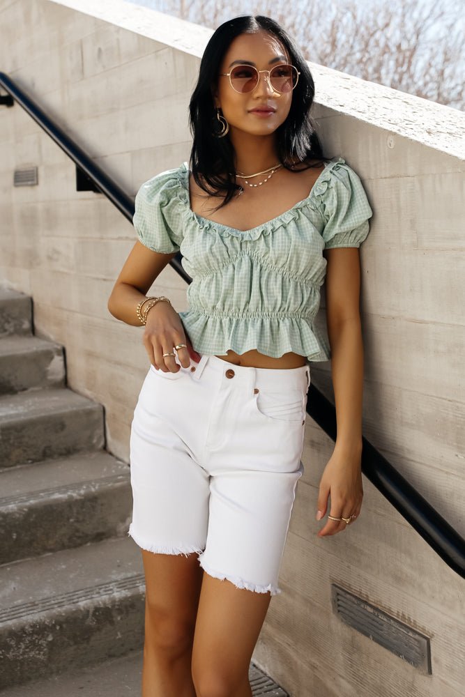 Denim short in white paired with a green top