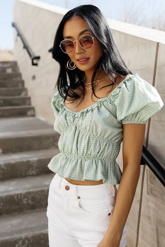 green ruffle blouse with short puff sleeves