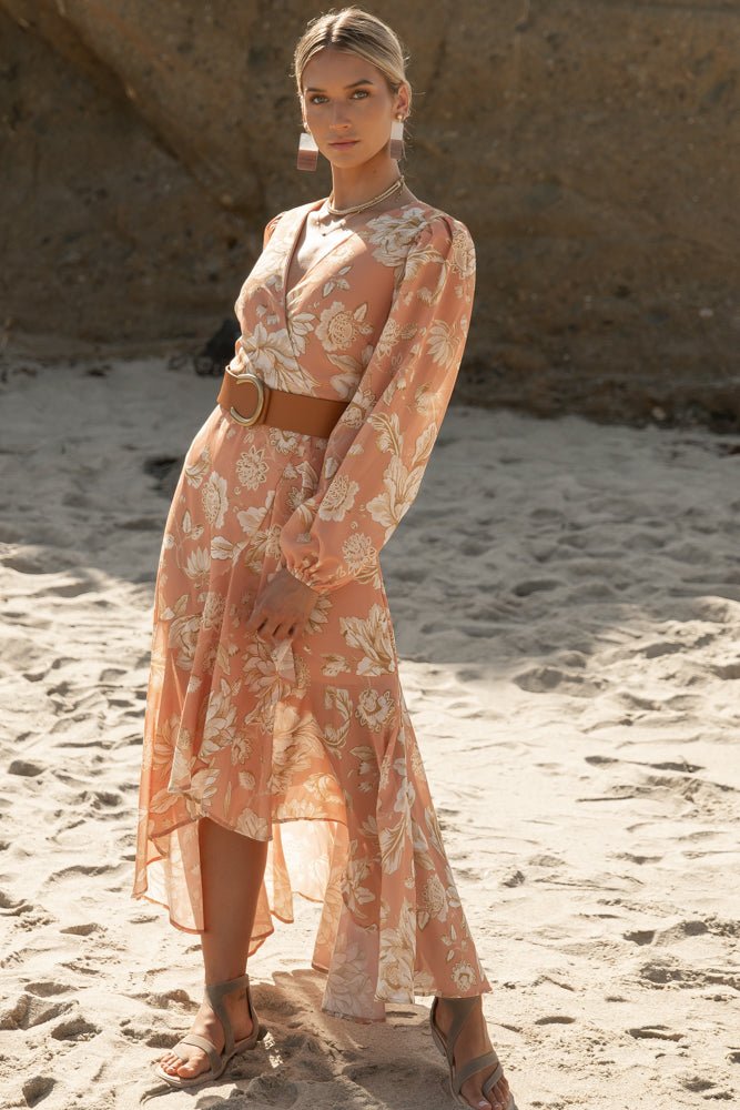 a woman at the beach wearing a maxi dress