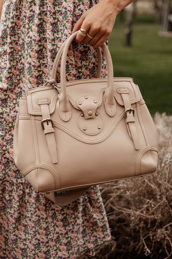 cream colored bag with buckle detail