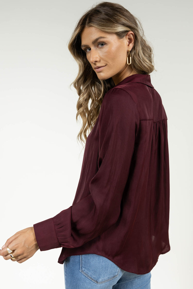 burgundy satin blouse with long sleeves