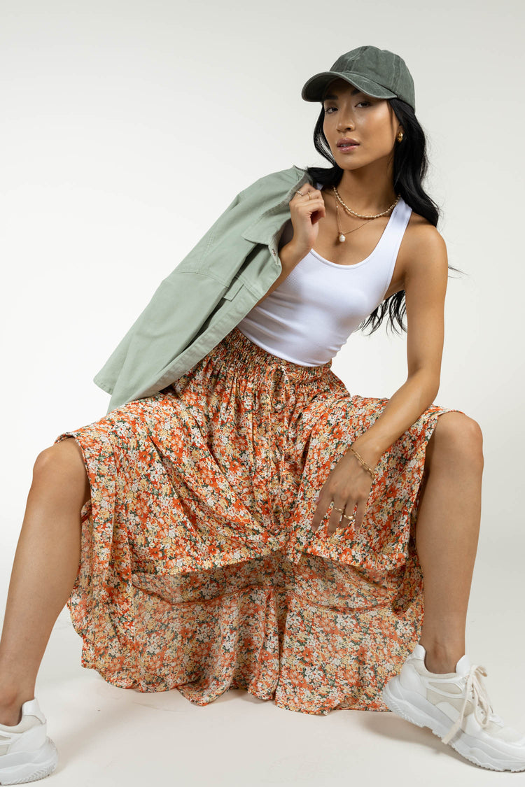 maxi floral skirt with baseball cap and sage jacket