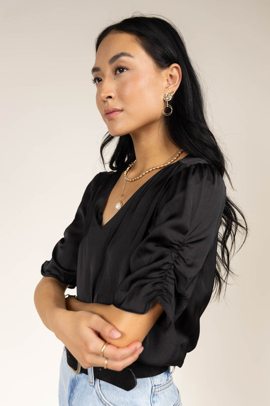 black blouse with ruched sleeve