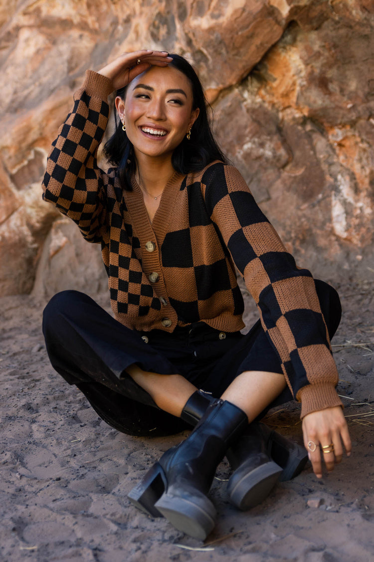 checkered sweater cardigan with black boots