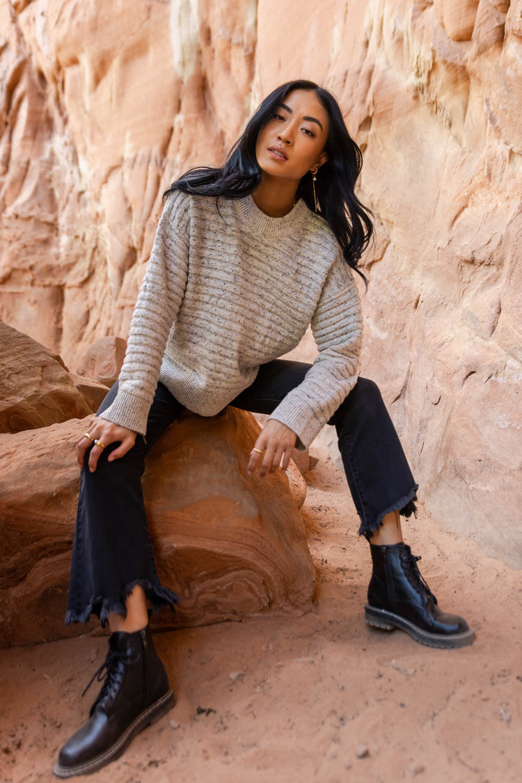 textured sweater with combat boots and black denim